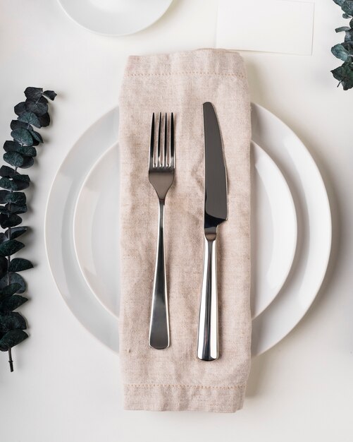 Top view of plates with cutlery and cloth