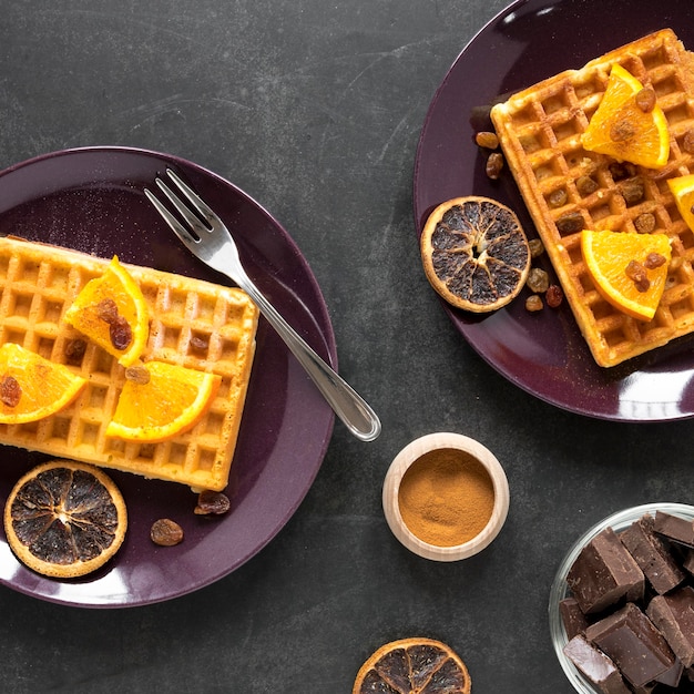 Free photo top view of plates with waffles and citrus