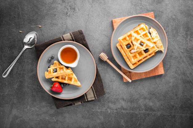 Top view plates with waffles and fruits