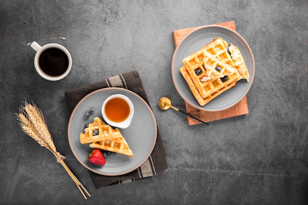 Top view plates with waffles with fruits