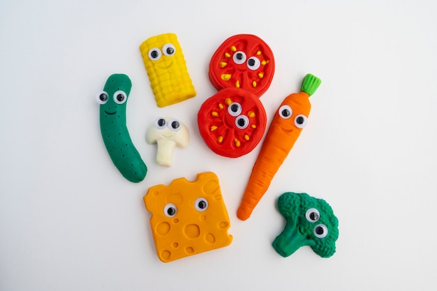 Free photo top view play dough background with vegetables