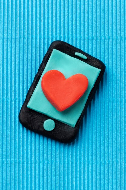 Top view play dough smartphone with heart