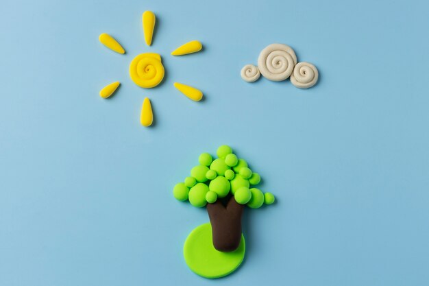 Top view play dough sun, cloud and tree