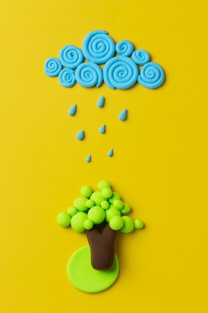 Top view play dough tree with raining cloud