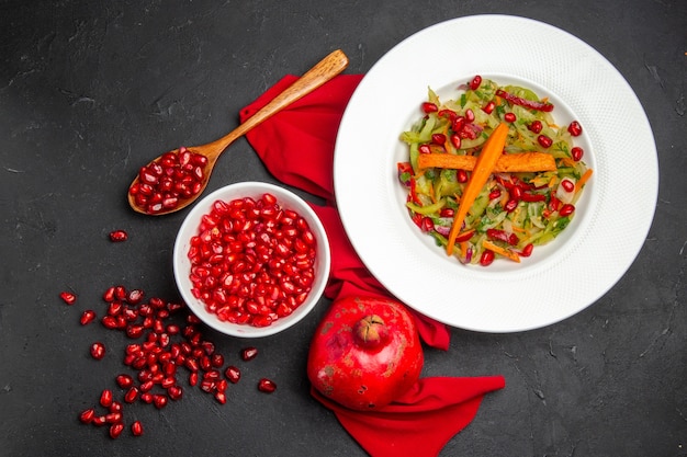 Top view pomegranate bowl of seeds of pomegranate tablecloth pomegranate vegetable salad