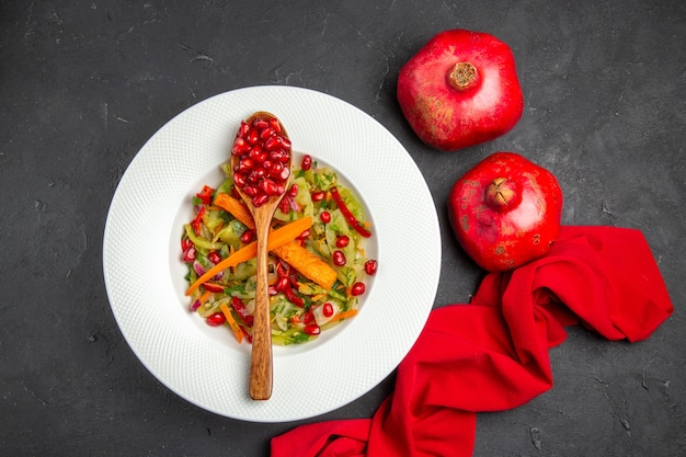 Top view pomegranate vegetable salad red tablecloth pomegranates