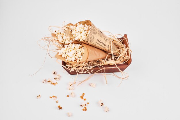 Top view of popcorn wrapped inside paper on white isolated.