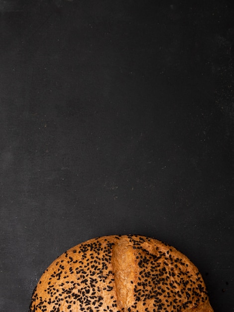 Free photo top view of poppy seed cob on black background with copy space