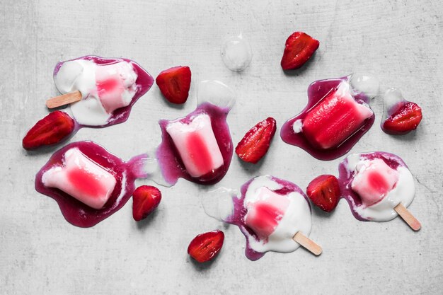 Top view of popsicles with strawberries
