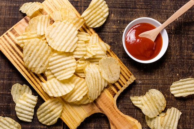Top view of potato chips with ketchup