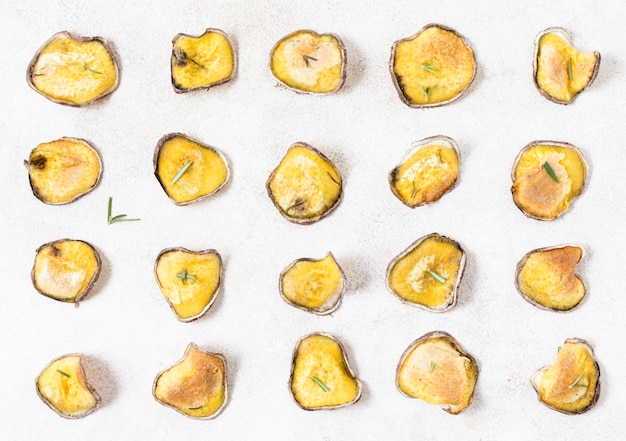 Top view of potato chips with rosemary