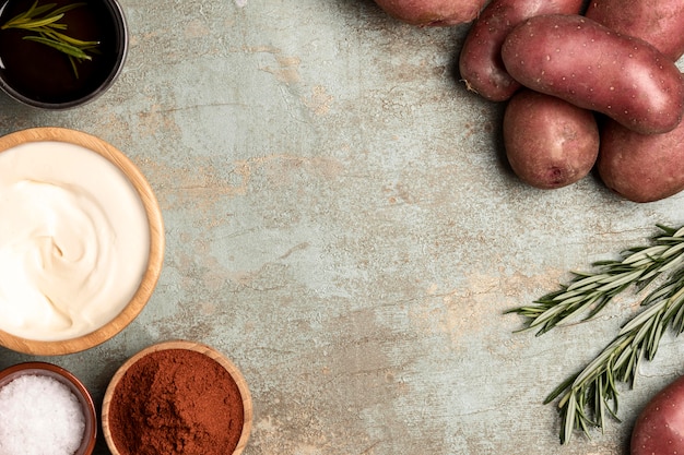 Top view of potatoes in bowls with rosemary