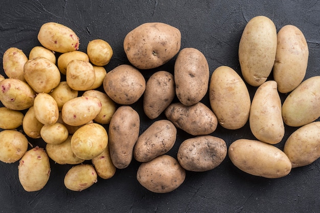 Top view potatoes overturned on table