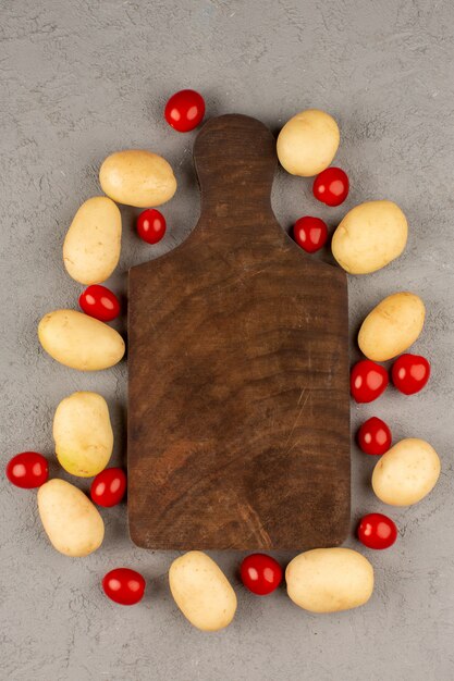 top view potatoes and tomatoes fresh whole on the grey floor