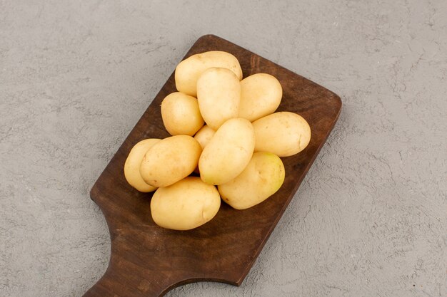 top view potatoes whole peeled out on the grey floor