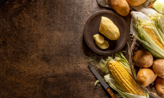 Free photo top view of potatoes with corn and copy space