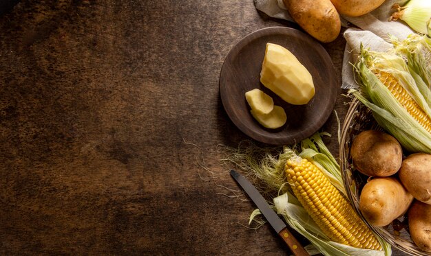 Top view of potatoes with corn and copy space