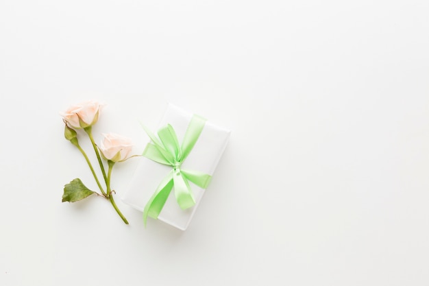 Top view of present with ribbon and rose