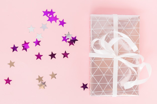 Free photo top view present with star confetti