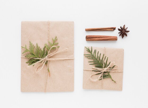 Top view of presents with cinnamon sticks and leaves