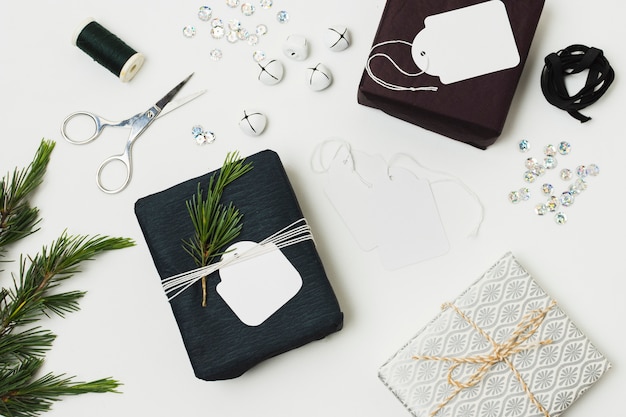 Top view of presents with tags and fern