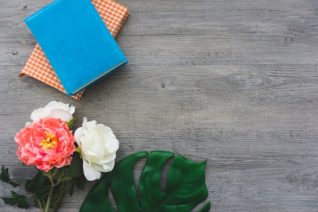 Top view of pretty flowers and decorative books