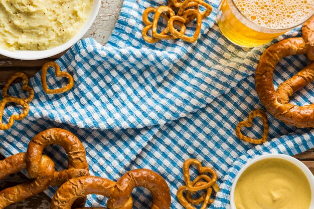 Top view of pretzels with beer and mustard
