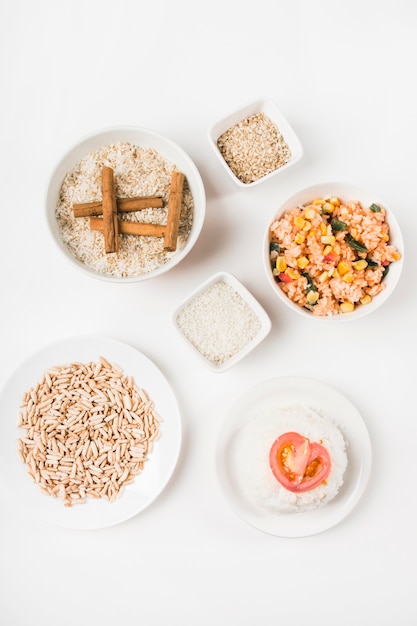 Top view of puffed rice; chinese fried rice and uncooked rice with cinnamon sticks