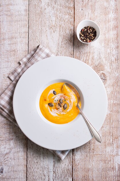 Top view of pumpkin puree dish on wooden board