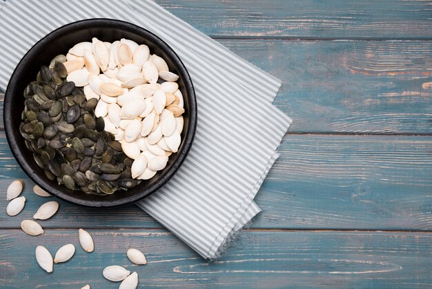 Top view of pumpkin seeds on wooden table