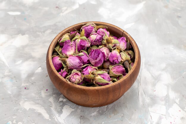 A top view purple flowers inside round bowl on the light desk flower plant color photo