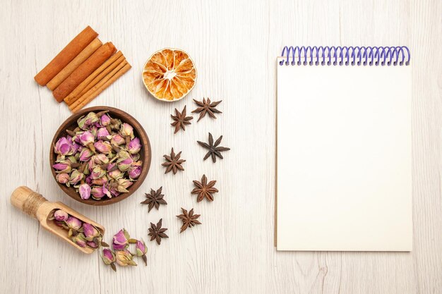 Top view purple flowers with cinnamon on a white desk color flower flavor