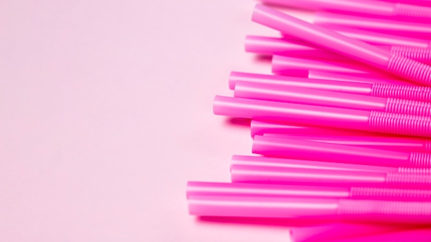 Top view purple plastic straws on table