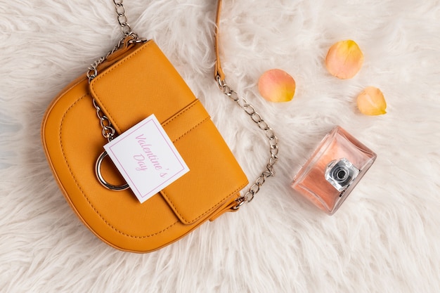 Top view of purse with rose petals and perfume from valentine's day