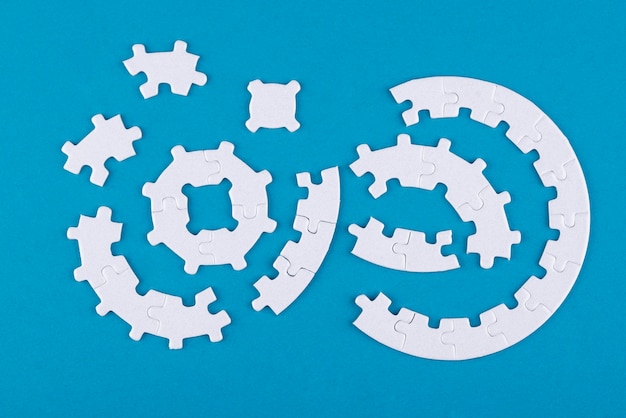 Top view puzzle pieces on blue background