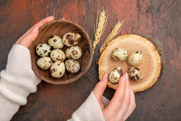 Top view quail eggs inside plate on dark tabl