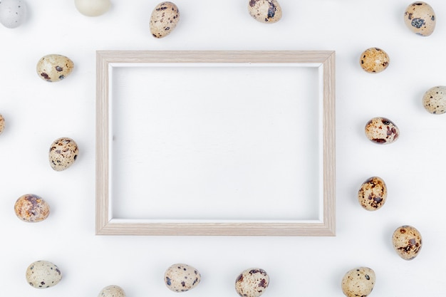 Free photo top view of quail eggs with cream colored shells with brown splotches on a white background with copy space