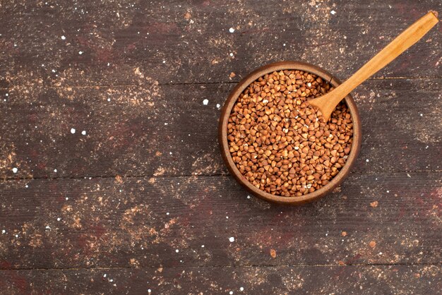 Top view raw buckwheat seeds inside brown grain seed food meal