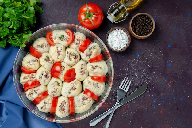 Top view raw dough pieces with ground meat and tomatoes on dark meal kitchen dish cuisine photo color food salad