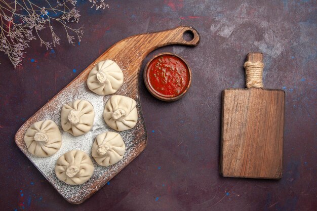 Free photo top view of raw dumplings dough on black