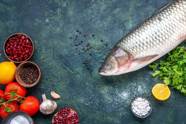 테이블 여유 공간에 있는 작은 그릇에 생선 토마토 마늘 채소 석류 다른 향신료를 상위 뷰