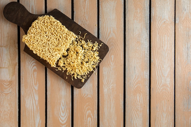 Top view of raw instant noodle on a wooden cutting board