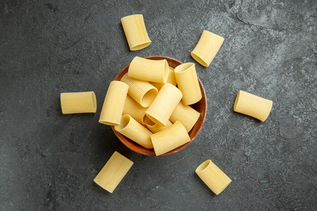 Top view raw italian pasta little formed on a grey background food pasta raw meal dough