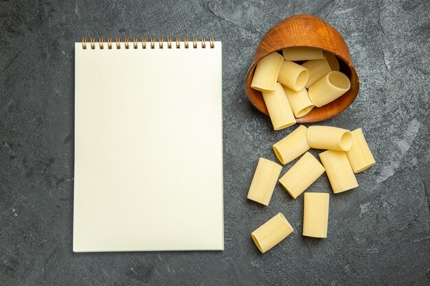 Top view raw italian pasta little formed on a grey background raw meal food pasta dough