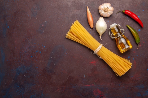 Top view raw italian pasta long formed on the dark-purple background meal food dough pasta raw