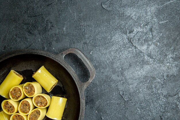 Top view raw italian pasta with meat inside pan on a dark background pasta dough meal food