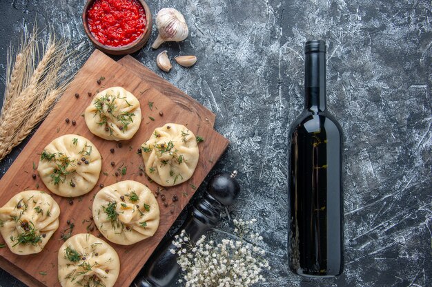 Top view raw little dumplings on light gray background meat dough meal cake dinner cooking cuisine