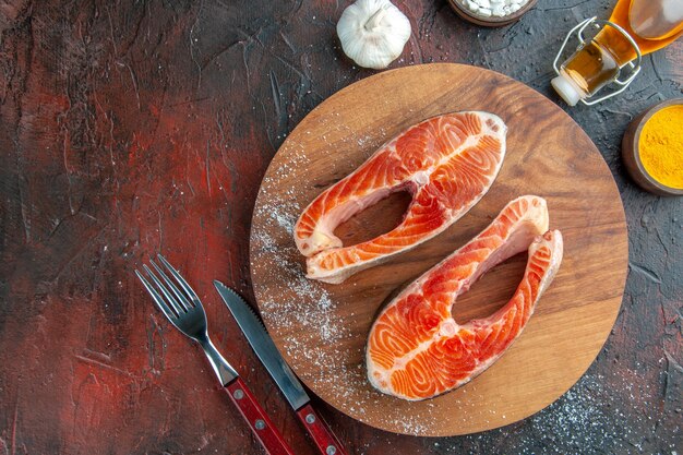 Top view raw meat slices on a dark background