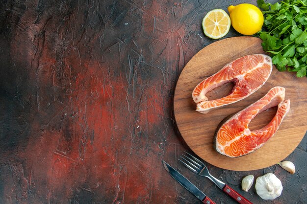 Top view raw meat slices on dark background