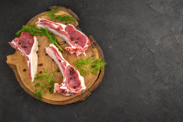 Top view raw meat slices with greens and pepper on gray background cow photo animal pepper chicken raw color